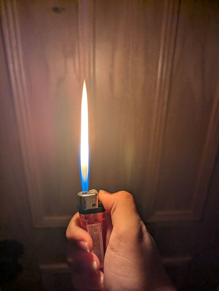 me holding a lighter that is slightly broken making the flame shoot super high