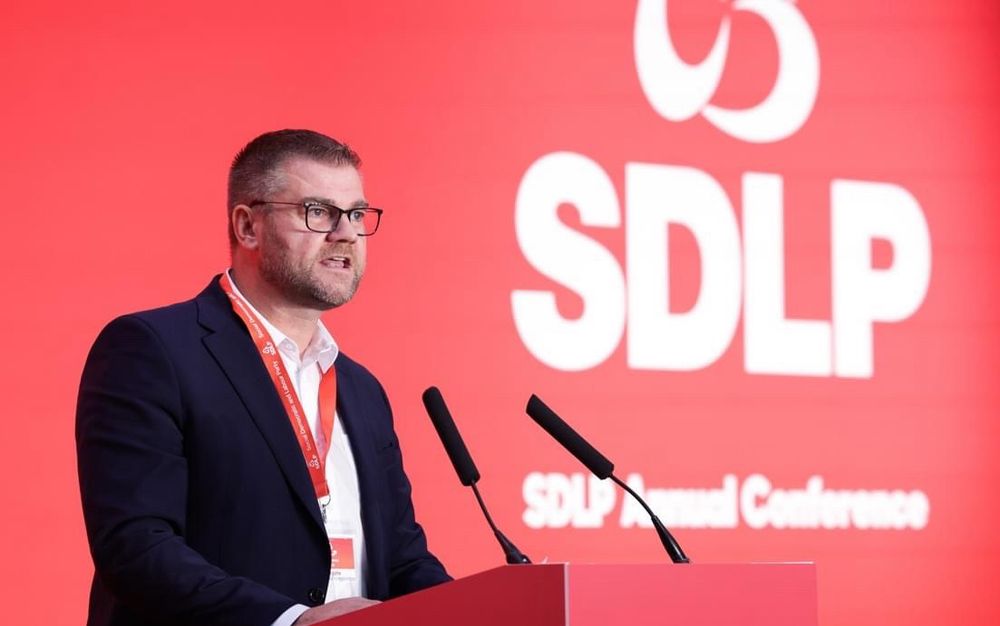 Photo of Colin in front of SDLP banner