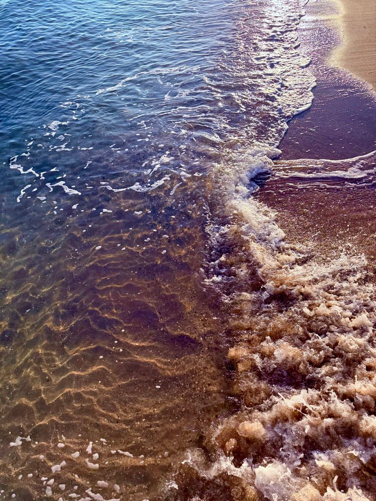 Waves breaking over the sand again. More foam this time