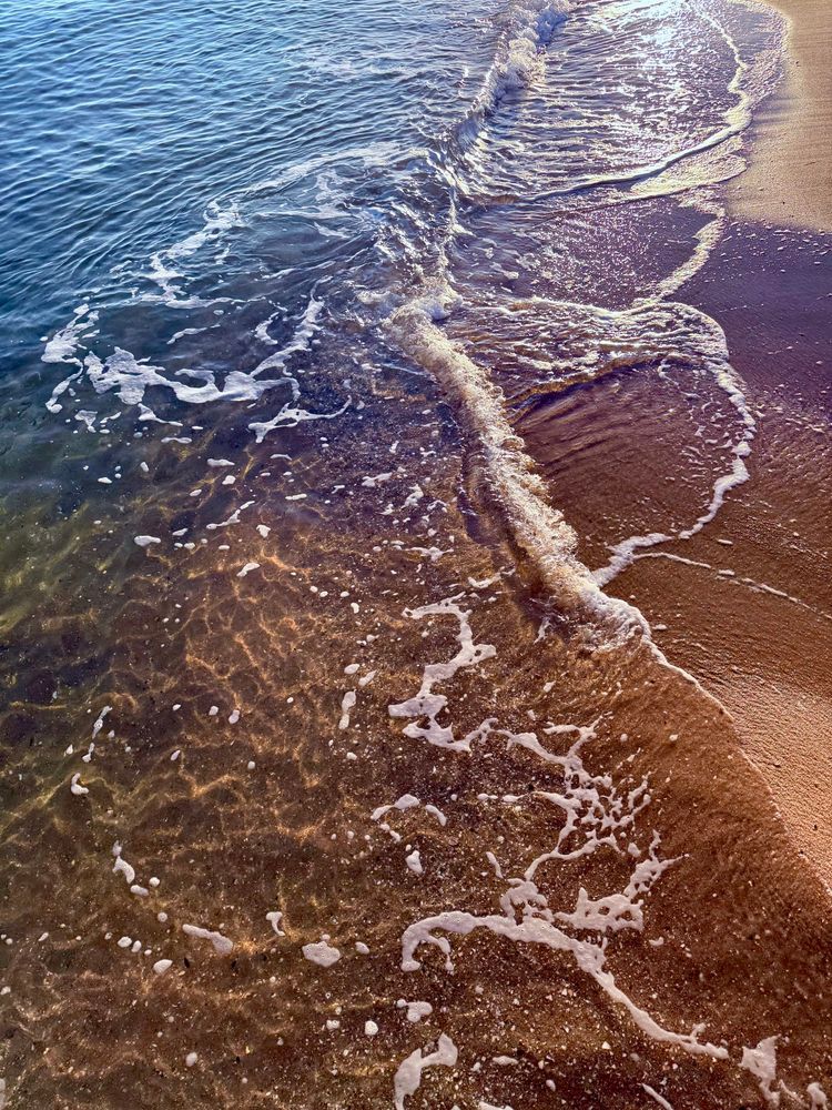 Waves breaking over the sand 