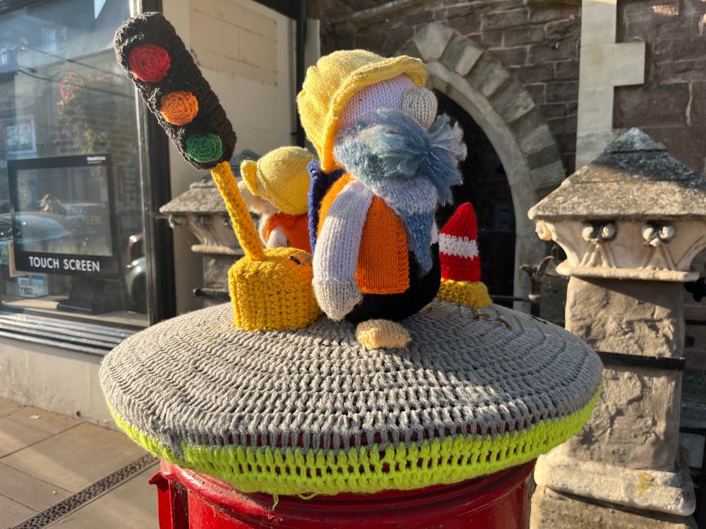 Knitted workmen and traffic lights postbox topper