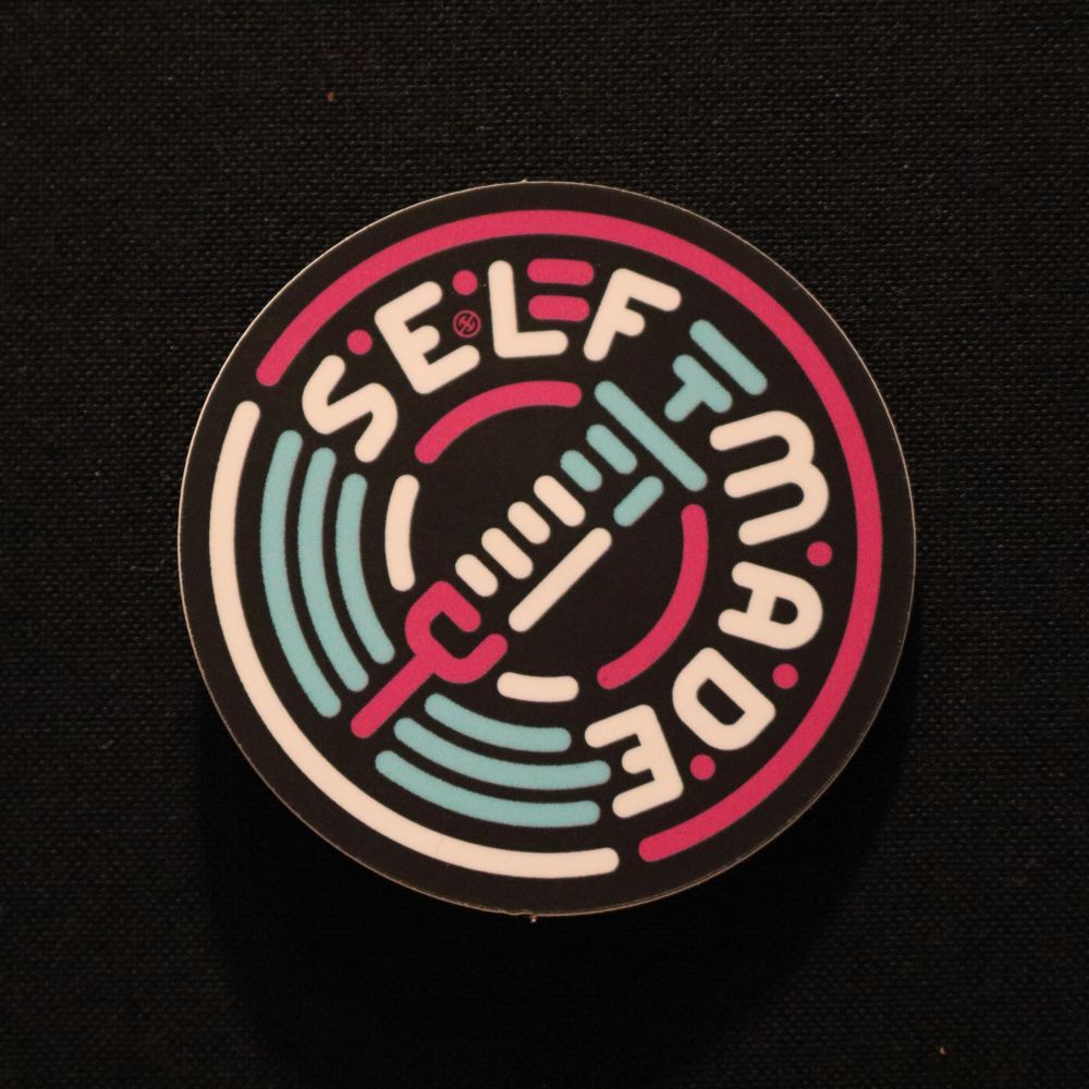 a neon syringe in a pink halo that reads SELF MADE