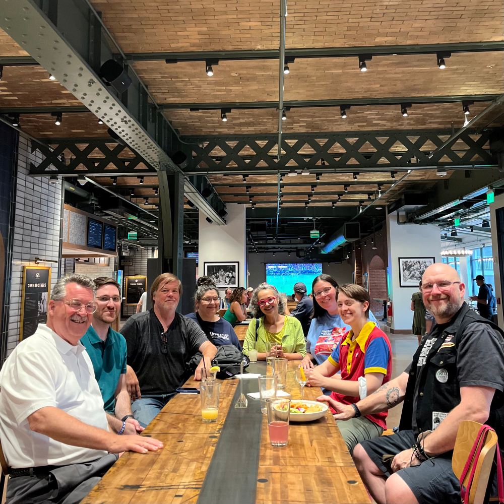 Members of the RI Freedom to Read coalition gather around a table at Track 15 in Providence. 