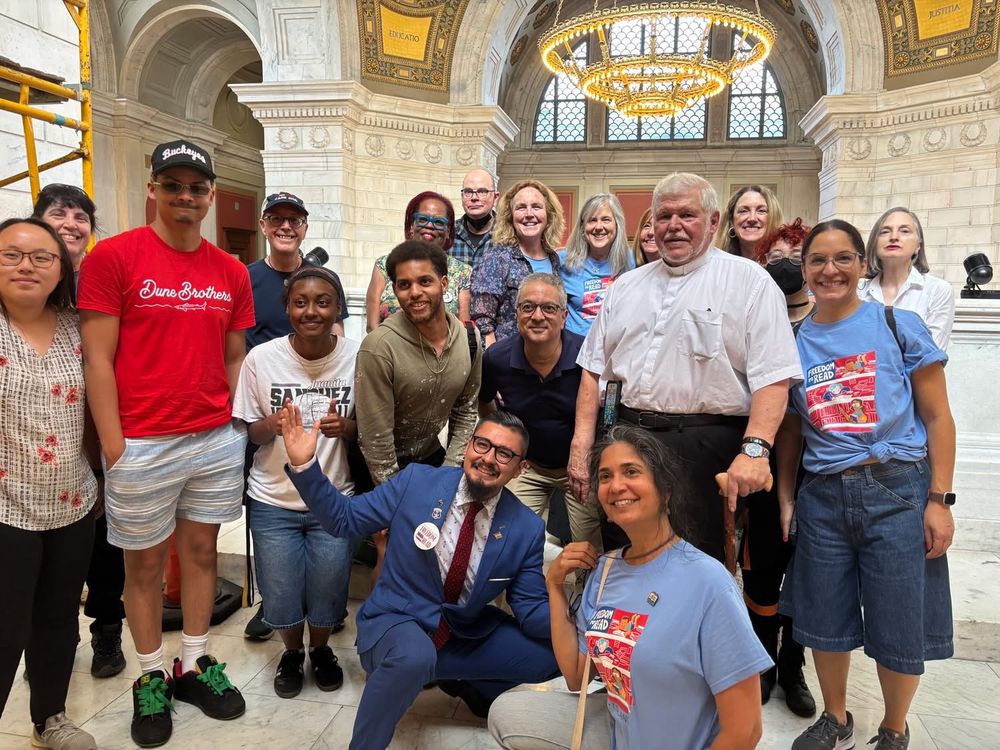 Freedom To Read coalition members pose with Rep David Morales in the rotunda of the RI statehouse on the night of the vote - June 16, 2025.  Several are wearing RI Freedom to Read t-shirts.