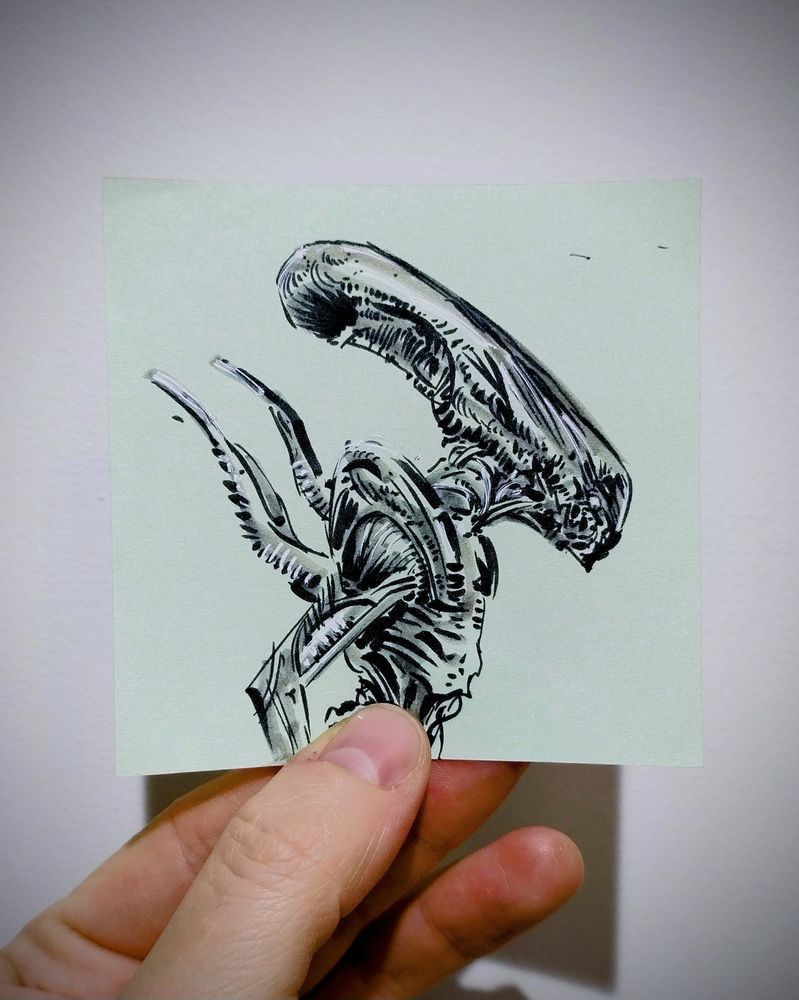 tiny xenomorph drawing made with black ink and white acrylic marker on post it paper sheet