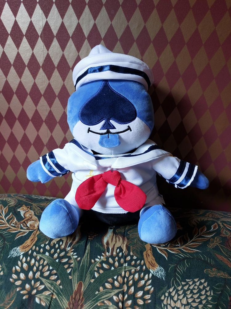 A plushie of Lancer from Deltarune, wearing a little sailor's outfit.