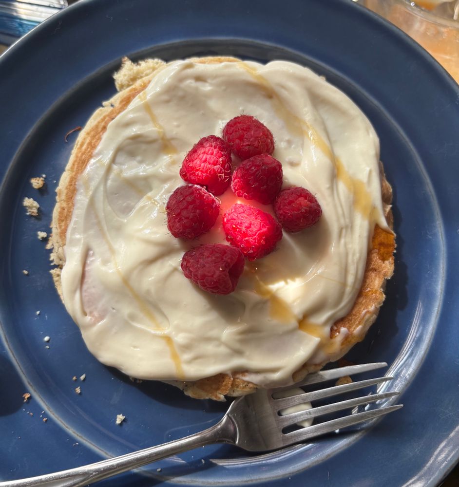 Whipped honey-ricotta pancakes with raspberries and honey drizzle 