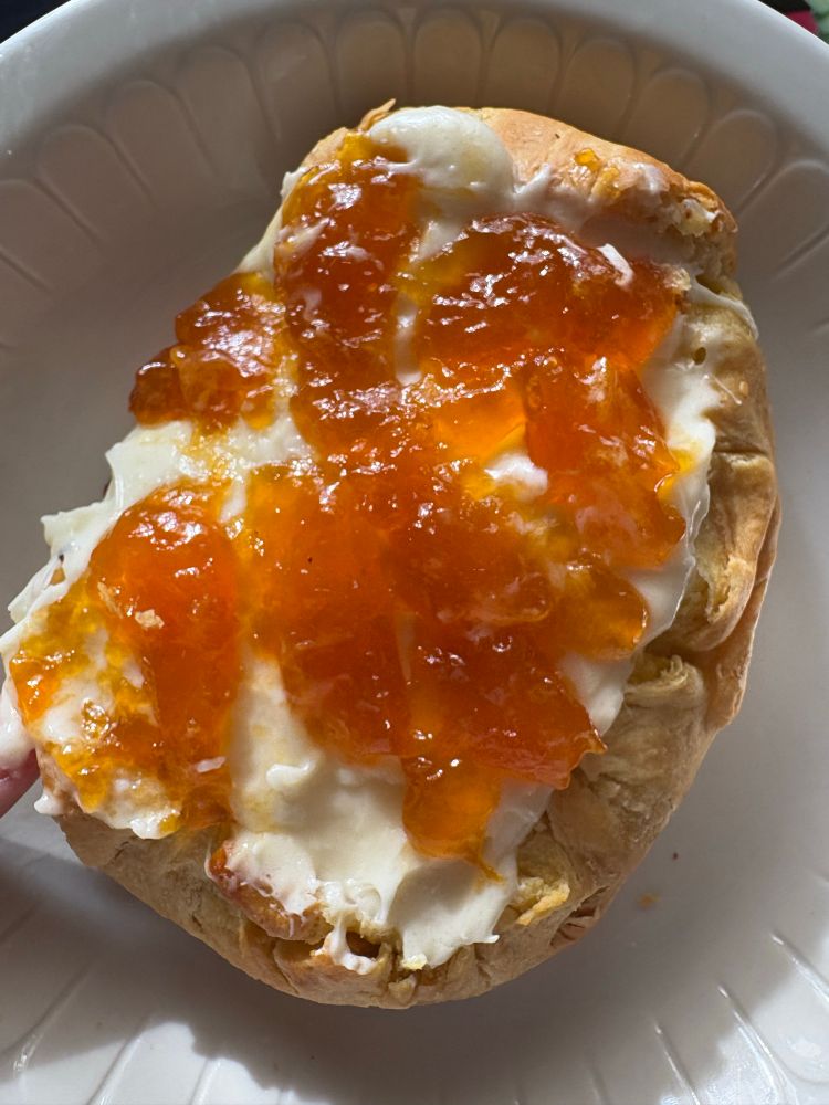 A puff pastry with cream cheese filling and apricot preserves 