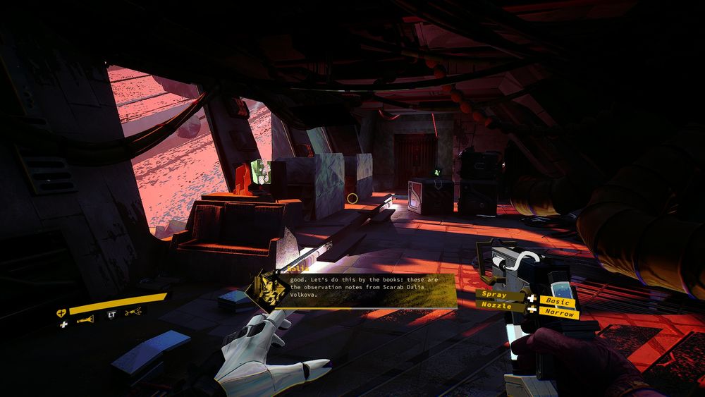 Screenshot from a first person perspective. A dark room on a spaceship with light shining in from a window with a large ringed planet visible outside