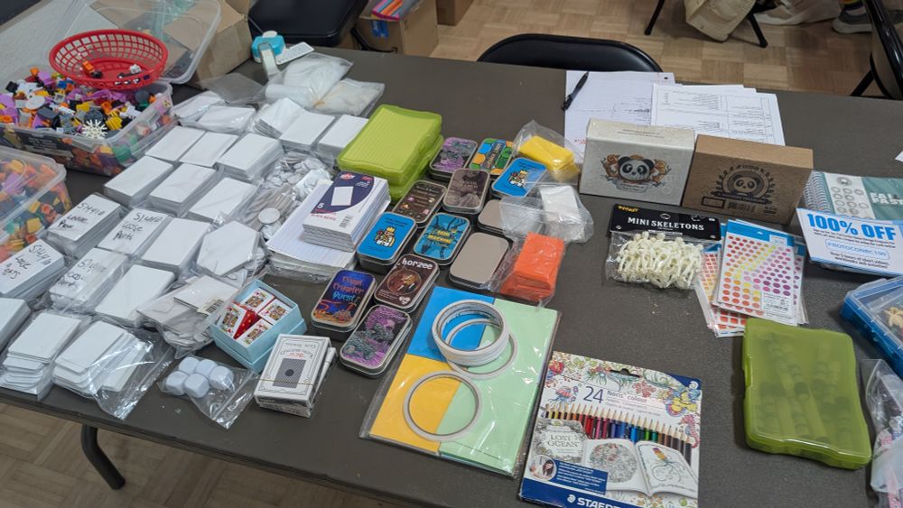 A table filled with miscellaneous game components, markers and blank tiles