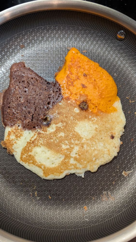 A multicolored pancake resembling a calico cat face