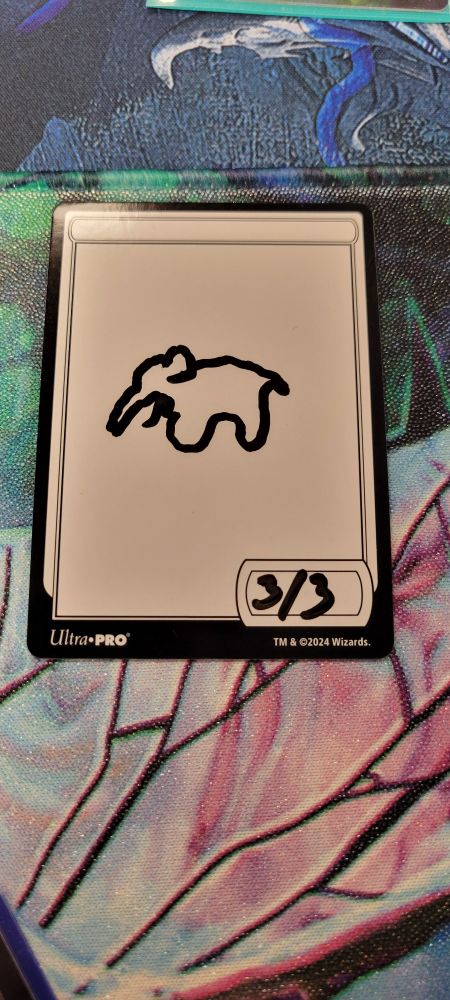 Magic the Gathering dry erase token with an elephant drawn on it.