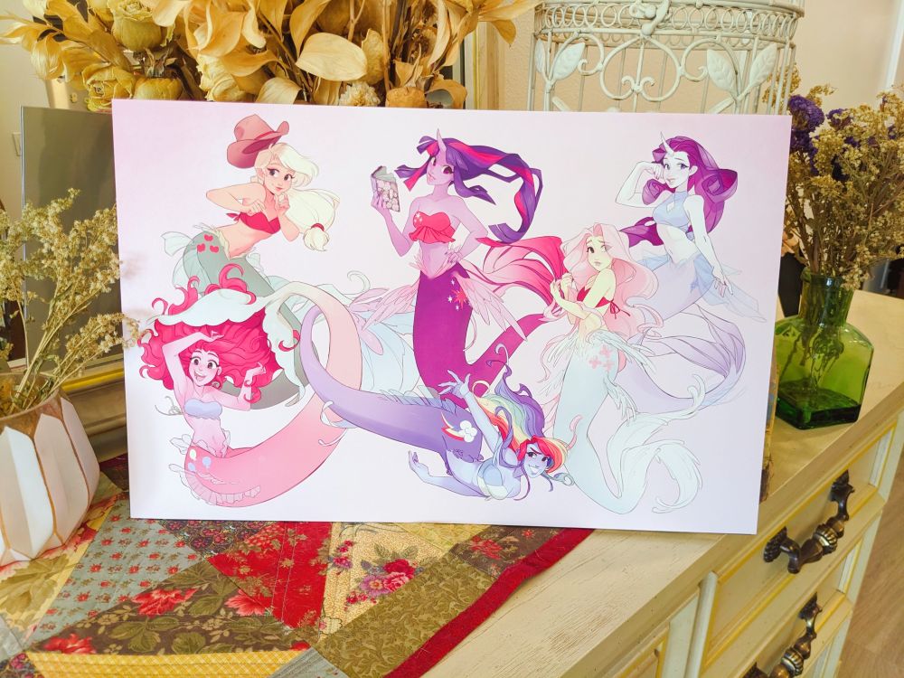 A photo of an 11x17 print featuring the Mane Six of My Little Pony: Friendship is Magic - as mermaids.