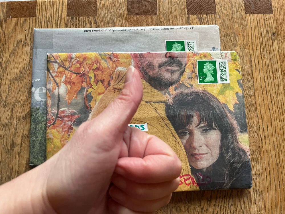 Two short-story pamphlets wrapped in colour pages from a newspaper supplement. A woman looks out from the page/parcel, directly at the viewer. 
