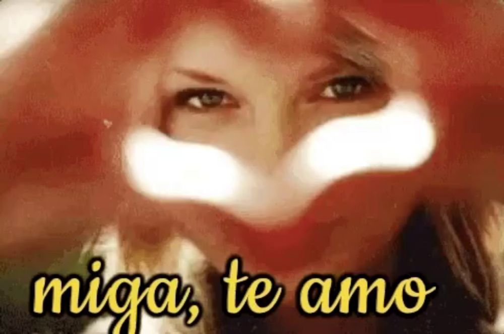 a woman is making a heart shape with her hands and the words miga te amo are above her