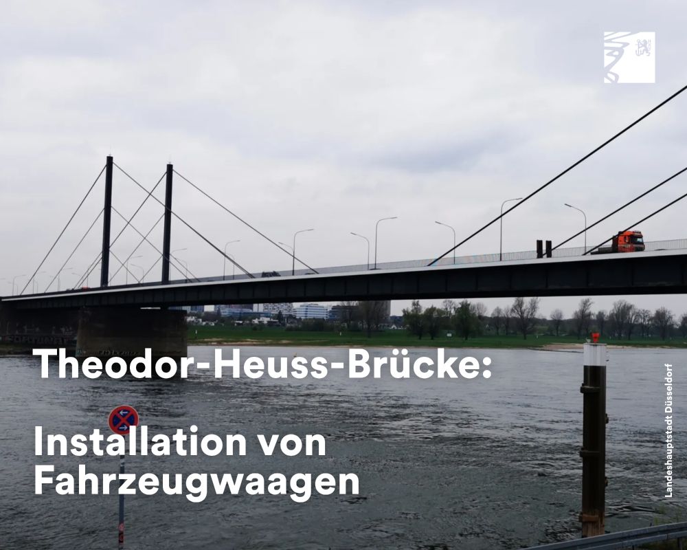 Die Theodor-Heuss-Brücke über den Rhein mit Fahrzeugen und installierten Fahrzeugwaagen unter bewölktem Himmel.