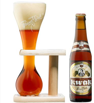 A bottle of Kwak Belgian Amber Ale, and its weird quacking glassware filled with the stuff sitting in its purpose-made holder
