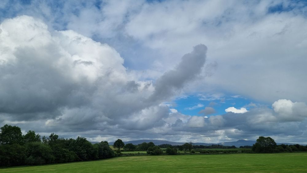English landscape, Ingleborough in distance, cloud shaped like a dick in centre