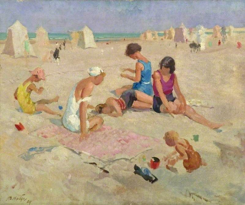 Family on the beach playing in the sand