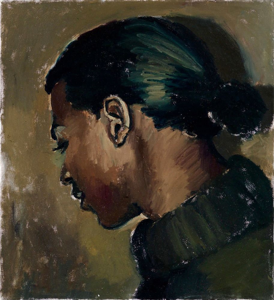 Portrait of a women, side profile, her hair is tied up, she wears a roll neck sweater