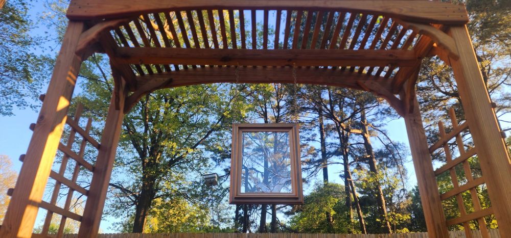 The same arbor and art piece during the day l, shot from below. It is spring time and very relaxing.
