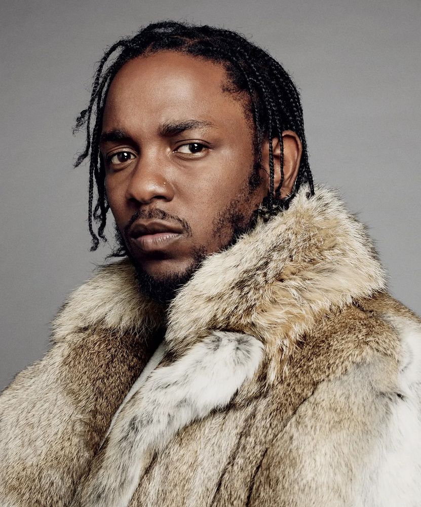 A colour photograph of Kendrick Lamar c. 2020, wearing a thick fur coat and looking into the camera.