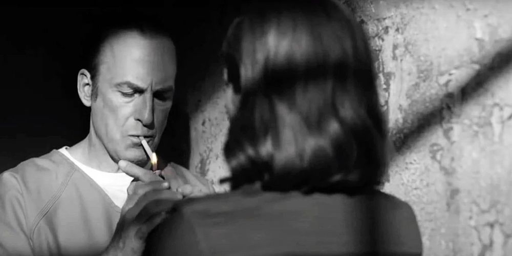 Kim (Rhea Seehorn) lights a cigarette for Jimmy (Bob Odenkirk) in "Saul Gone" (Better Call Saul, season 6 episode 13).
