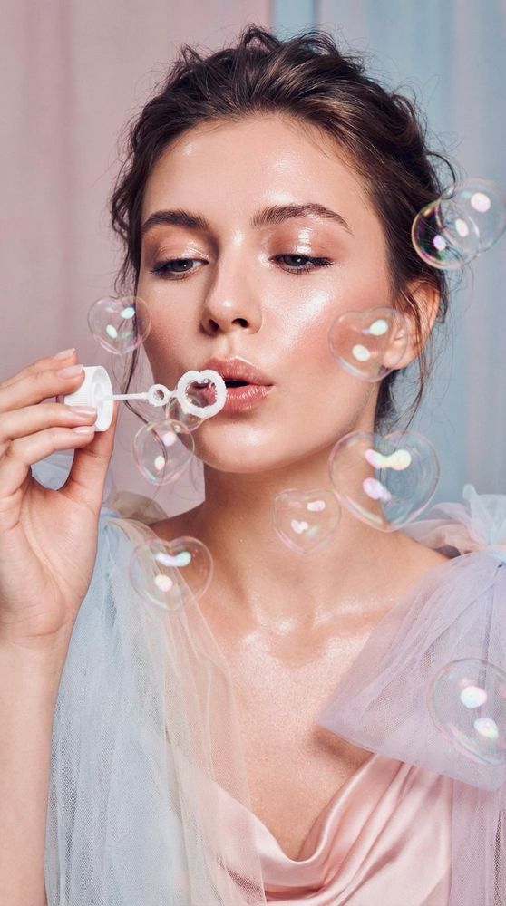 Closeup, a beautiful stunning woman in pastel couture, blowing heart shaped bubbles, many heart shaped bubbles, pastel minimalism background, glossy, fashion photography lighting,