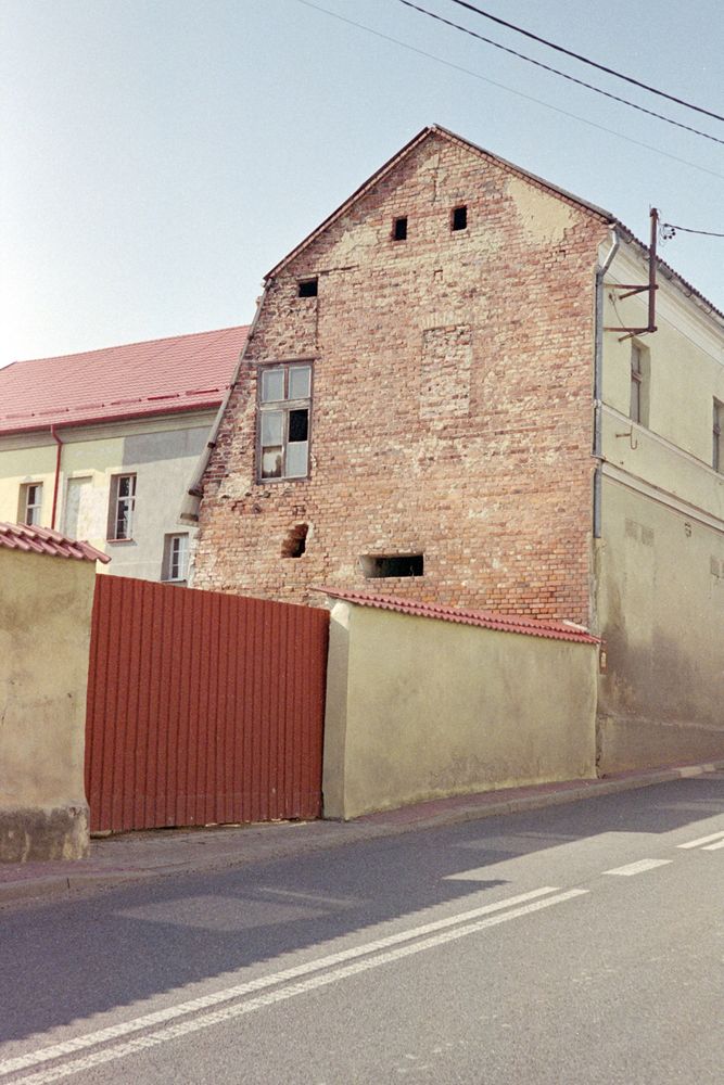 a strange exposed wall of a building with an oddly placed window 