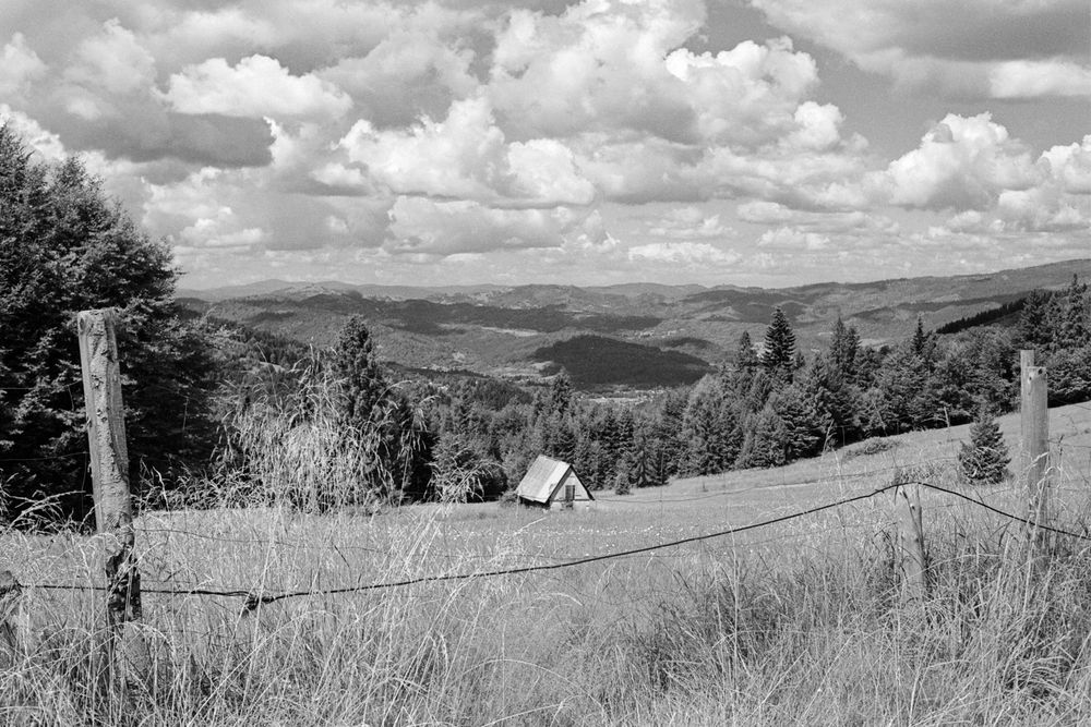 a mountain view behind some fencing