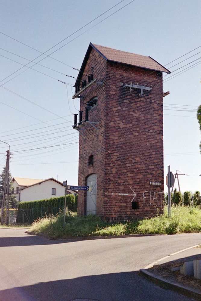 some kind of an old brick electric tower (I don't even know what it's called it in Polish let alone English) at a crossroad