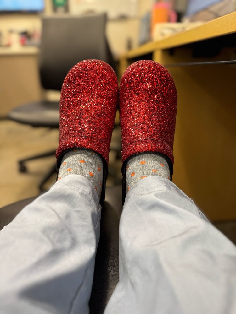 Picture of Red glitter Danskos, blue scrubs pants. 