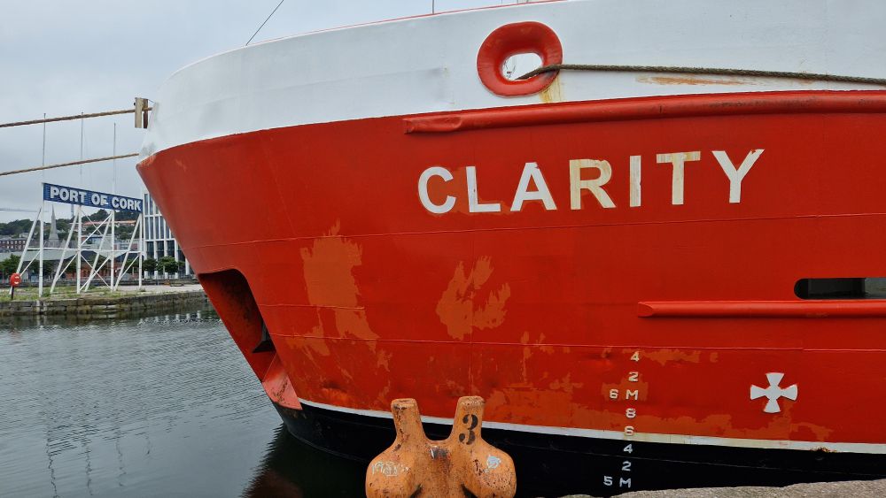 Orange bow of ship called "Clarity". Port of Cork sign in background 