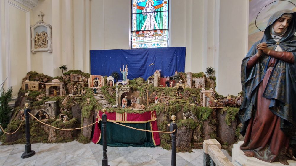 Nativity scenes . Large statue of Out Lady beside it