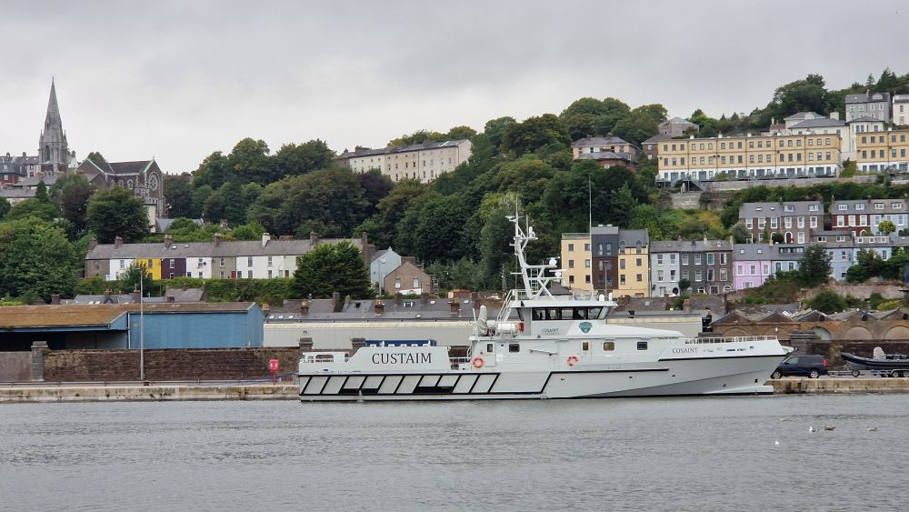 Grey coloured customs cutter docked.