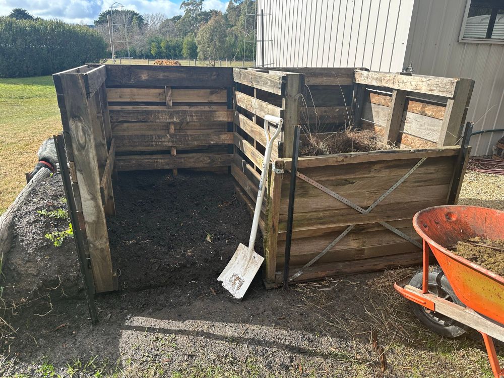 Photo of twin composting bays, made from star pickets and old pallets