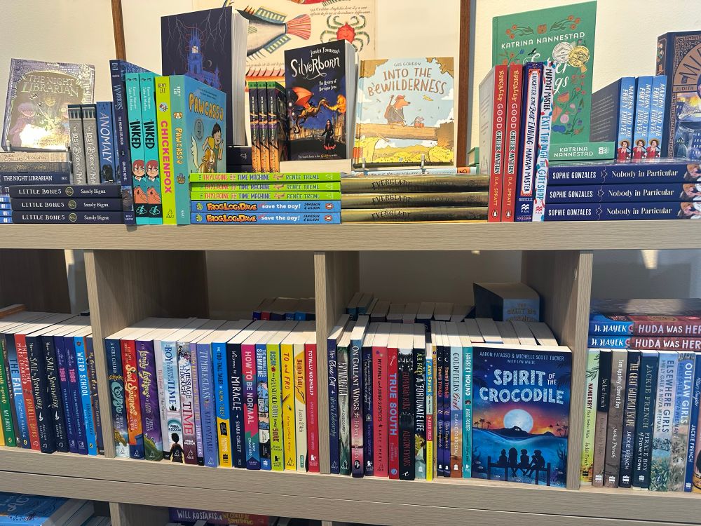 Photo of a bookshelf full of middle grade titles. Spirit of the Crocodile is turned face out. 