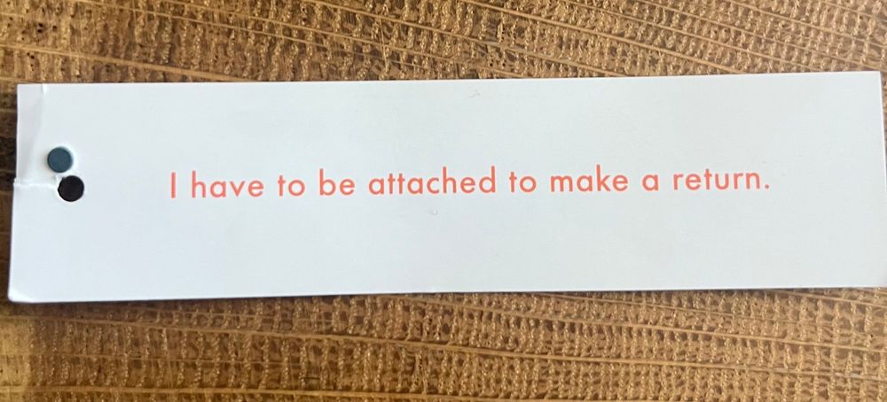 Tag reading “I have to be attached to make a return.”