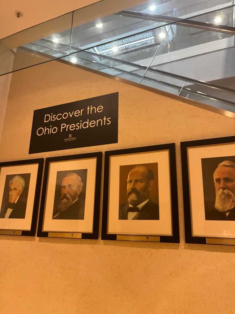 Four presidential portraits, under a sign reading “Discover the Ohio Presidents”