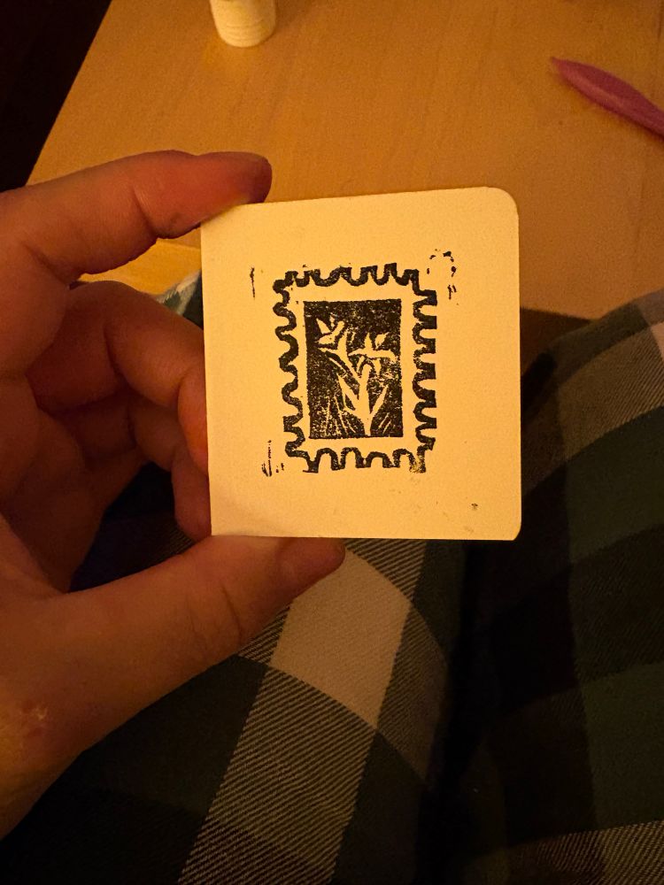 A closer photograph of one of the mini cards, held by Kaz to show it is about the size of his palm (he has small hands tbf) 