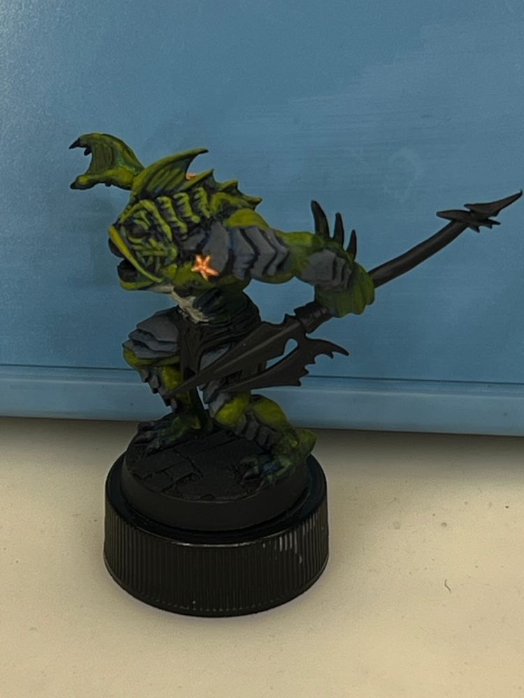 Largely painted miniature, an abomination from the board game HeroQuest. This is the revised paint job in green. Left side view. Some of the original blue is visible here and there, seems to make for slightly more interesting shadows. 