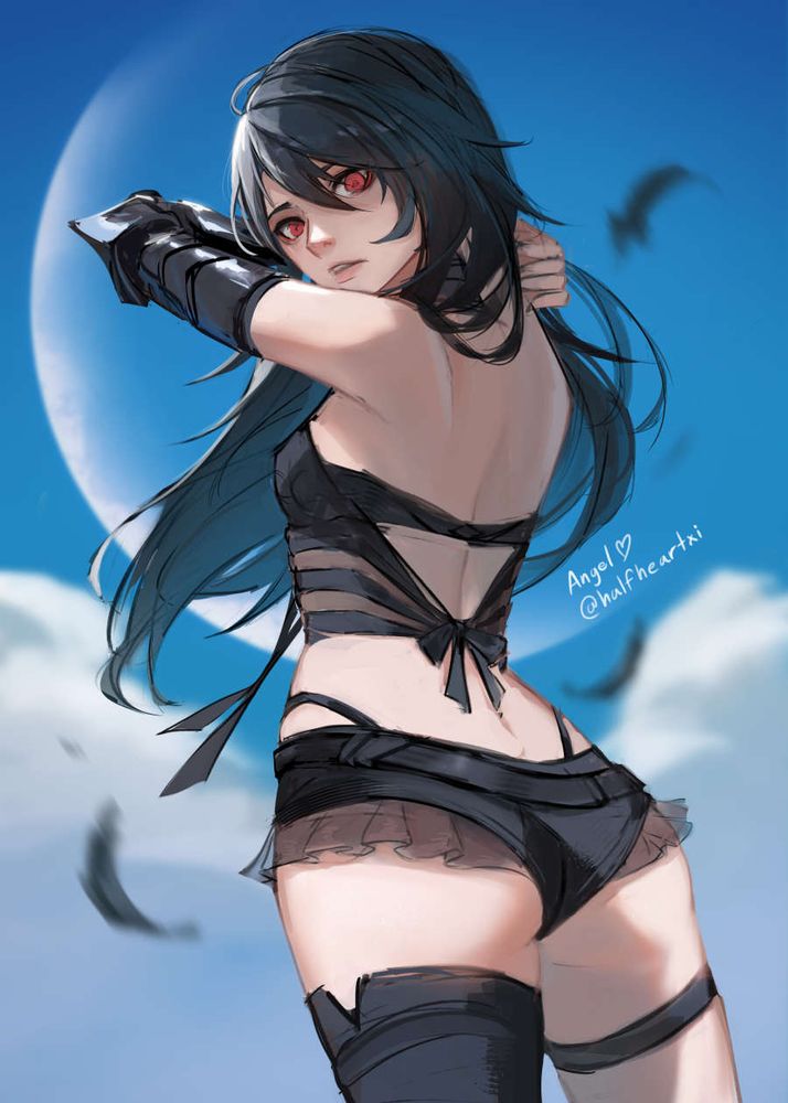 Raven posed in front of blue sky with feathers falling around her.