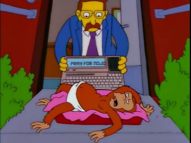 Mojo the monkey lies exhausted on a mat at the door of his trainer after an experience with Homer. He types “Pray for Mojo” into a device with a screen. 