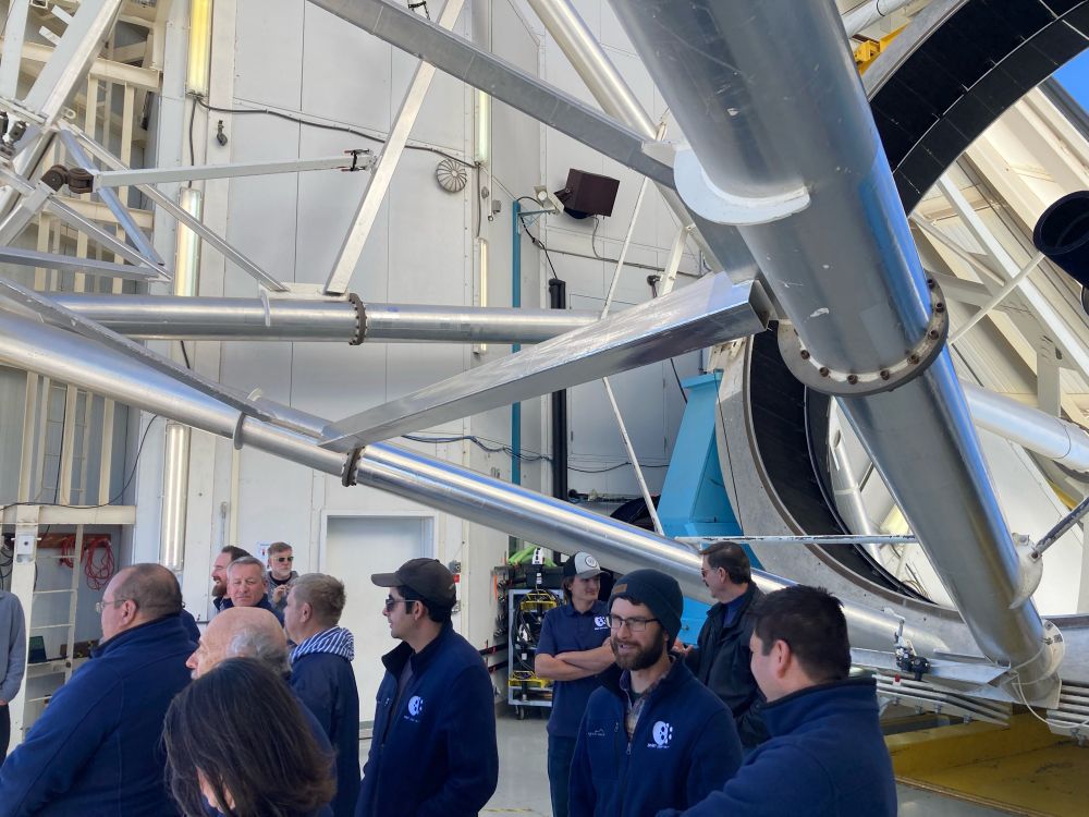 Observatory staff people below the structure of the MMT telescope