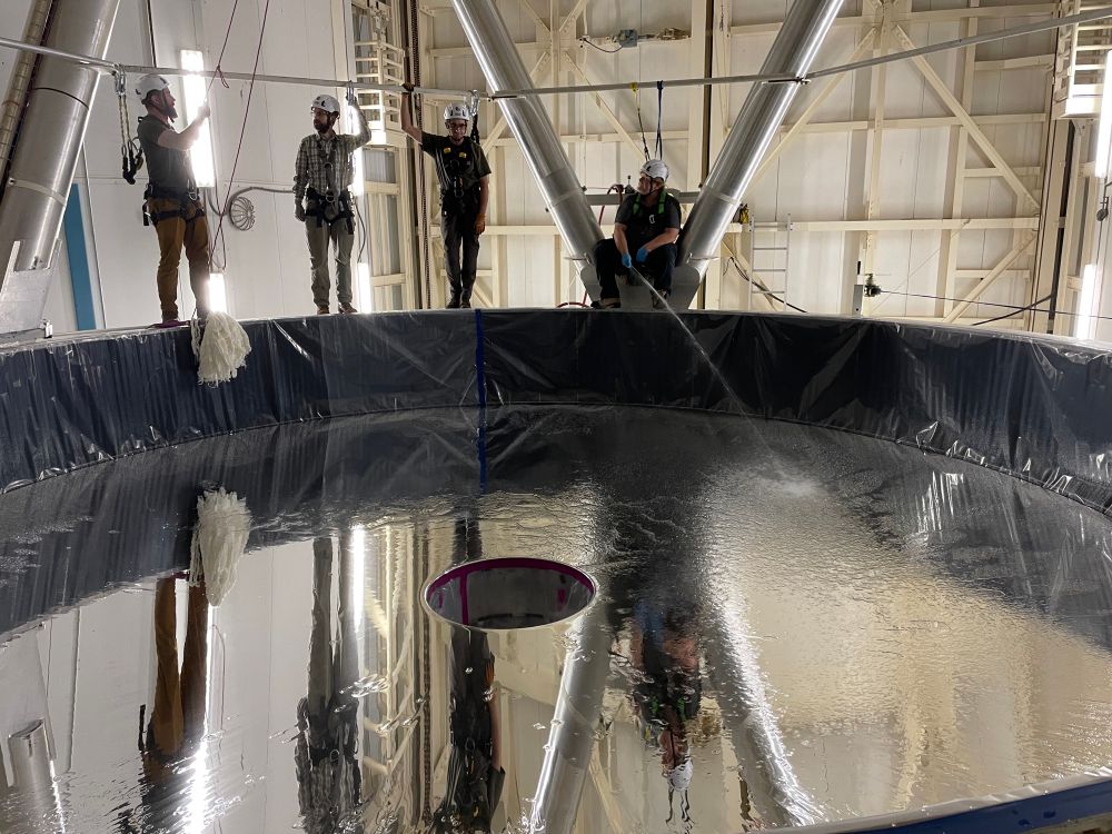 The primary mirror is sprayed with water to start dislodging dust and foreign particles while the day crew prepares the mops. 