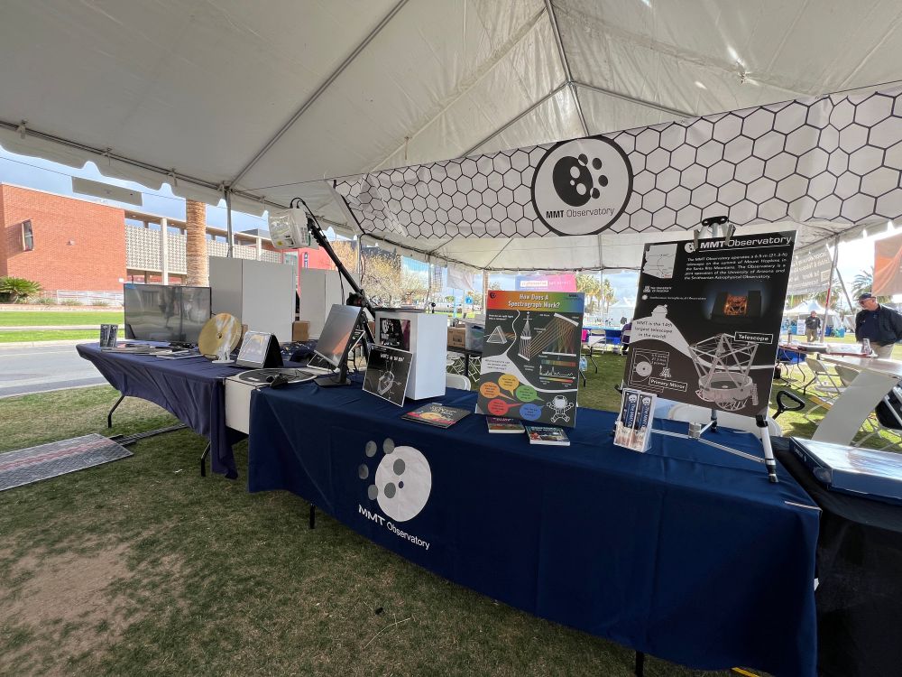 Booth at the Tucson Festival of Book. There are a variety of posters and books on display 