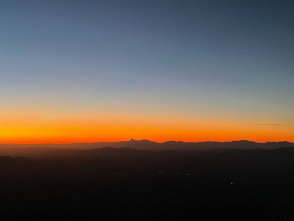 Orange sunset over distant mountains