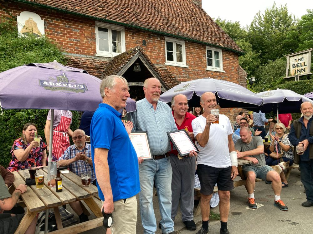 Landlord Hugh holding 2 awards. His brother and 2 CAMRA branch chairpersons.