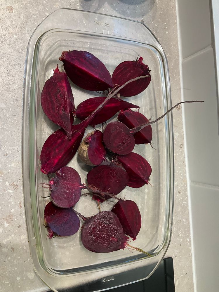 Picture shows a glass tray with an array of deep red beetroots halved
