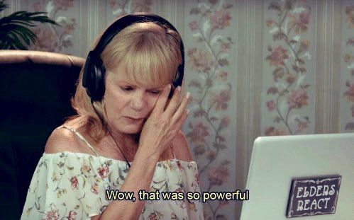 Woman wearing headphones wiping away tears with a caption of her saying “wow, that was so powerful”